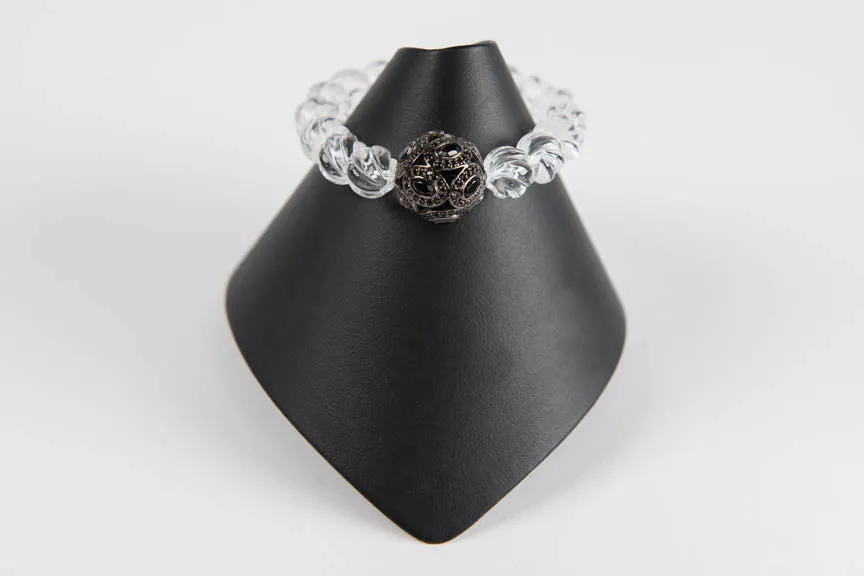 Carved rock crystal and black spinel bead