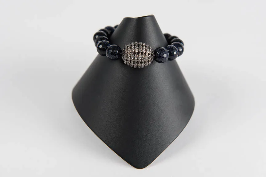 Navy goldstone with white topaz bead